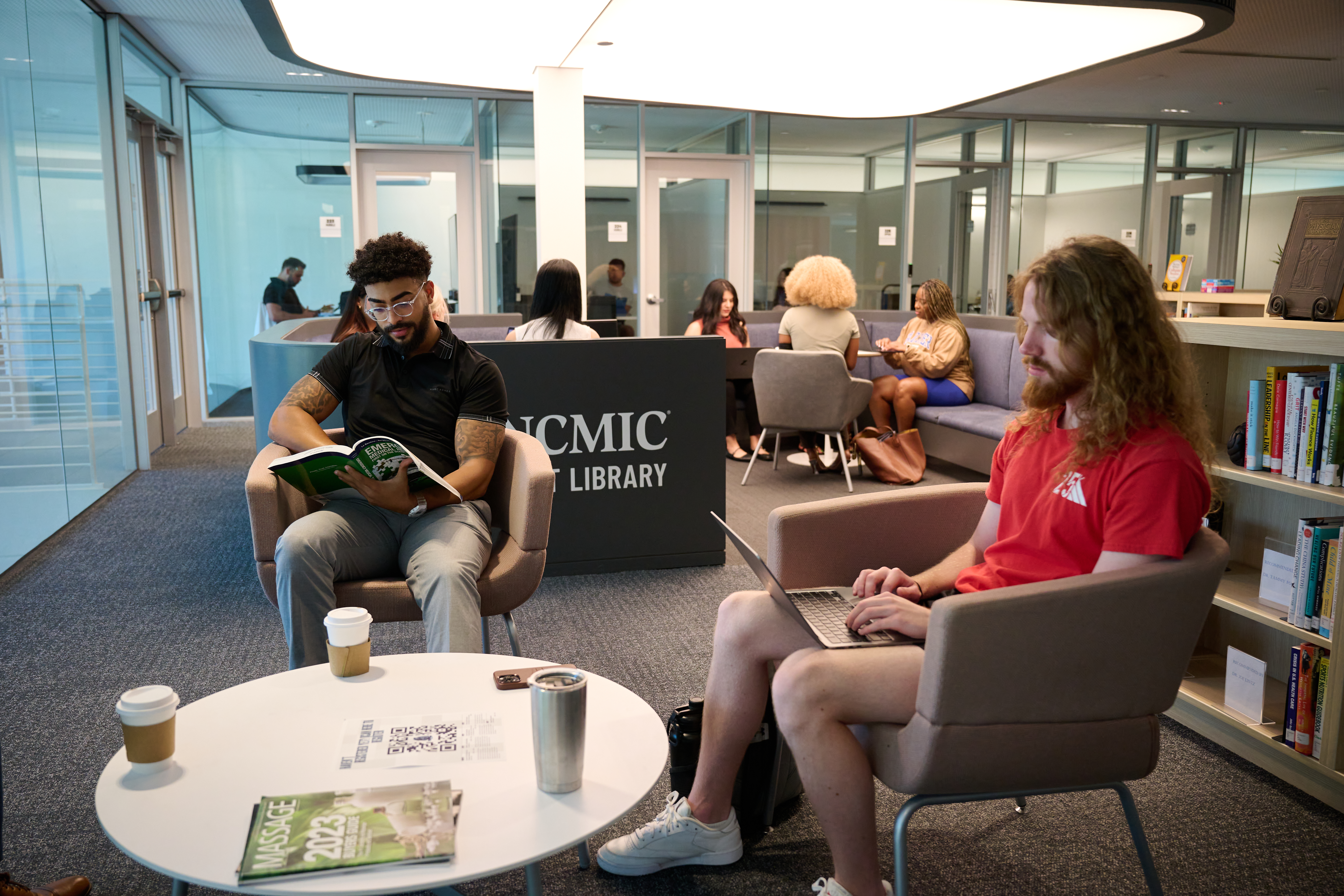 Two students sitting in the Parker University Library